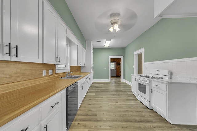 kitchen featuring white range with gas stovetop, white cabinetry, sink, and black dishwasher