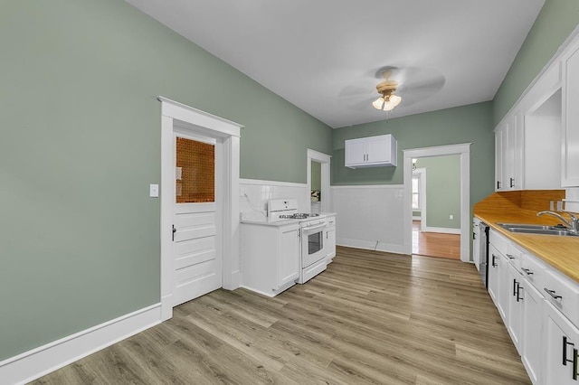 kitchen featuring white cabinets, light wood-type flooring, sink, and white range with gas cooktop