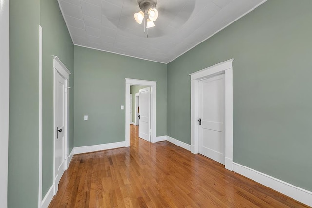 unfurnished bedroom featuring light hardwood / wood-style flooring, ceiling fan, and a closet