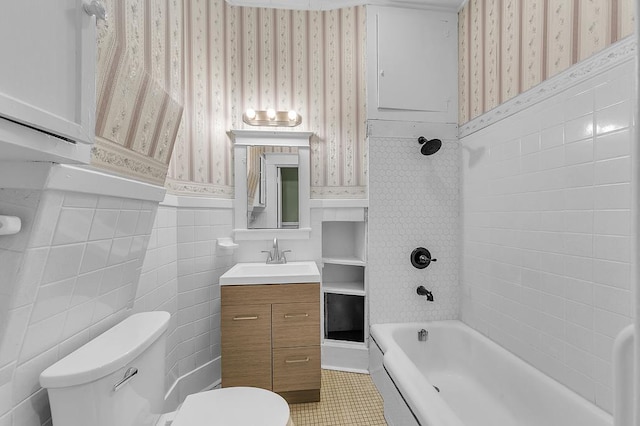 bathroom featuring tile patterned floors, vanity, tile walls, and toilet