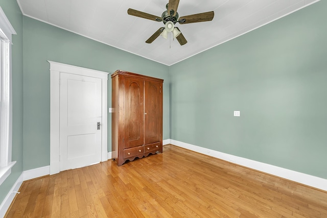 unfurnished bedroom with ceiling fan and light wood-type flooring