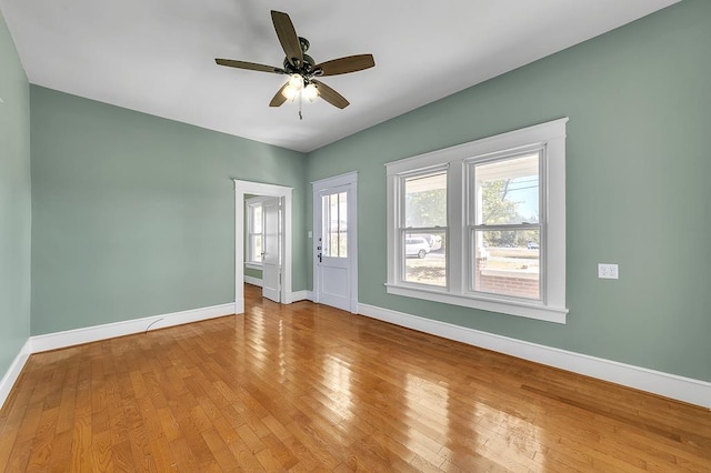 empty room with ceiling fan and wood-type flooring