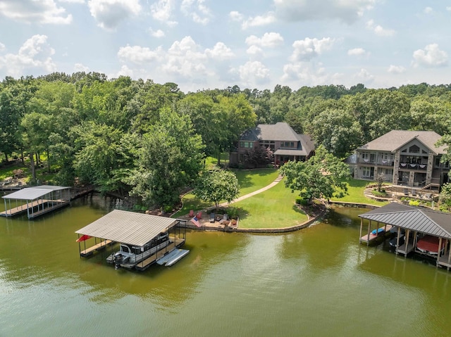 view of dock with a yard and a water view