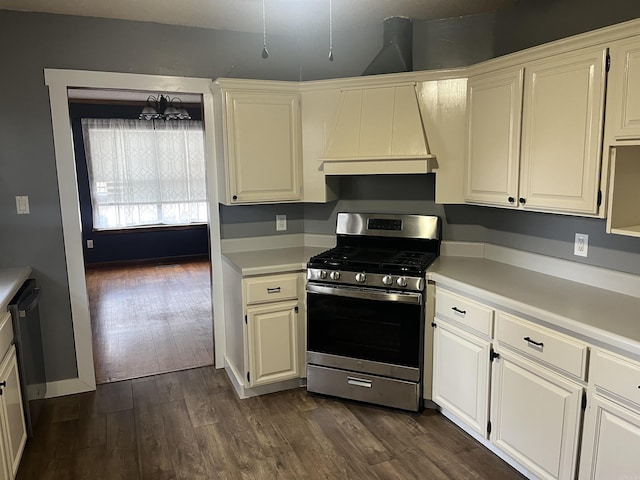 kitchen with dark hardwood / wood-style floors, white cabinetry, custom exhaust hood, and stainless steel range with gas cooktop