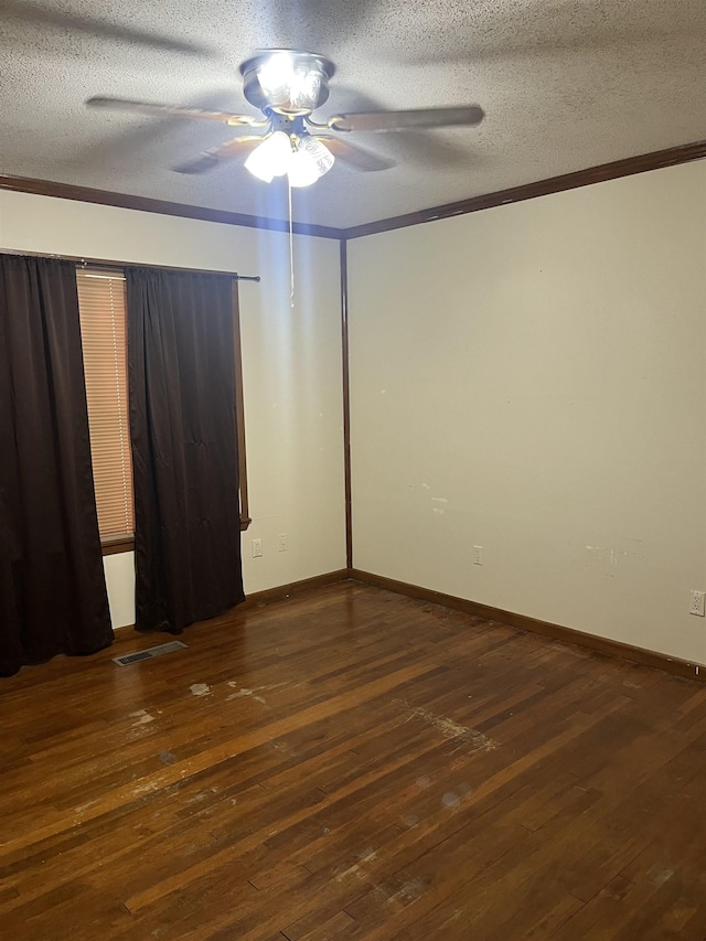 spare room with a textured ceiling, crown molding, dark hardwood / wood-style floors, and ceiling fan