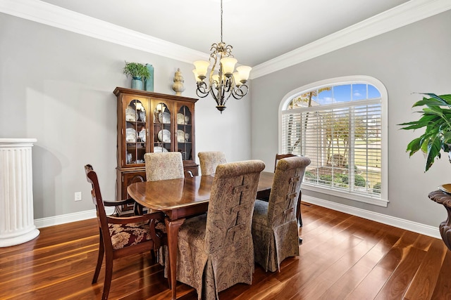 dining room featuring an inviting chandelier, dark hardwood / wood-style flooring, and ornamental molding