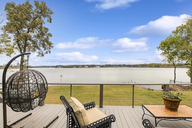 deck featuring a water view and a lawn