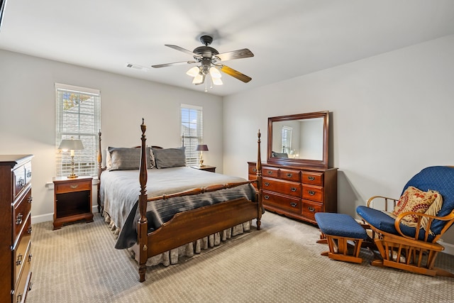 bedroom featuring light colored carpet and ceiling fan