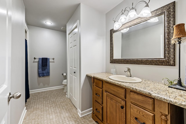 bathroom with vanity, tile patterned flooring, and toilet