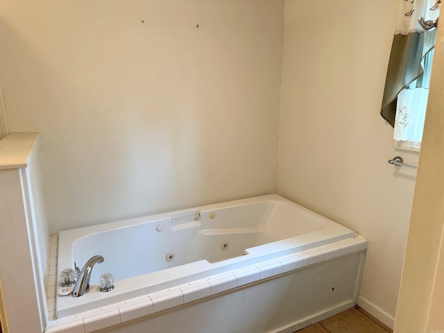 bathroom with tile patterned floors and tiled tub