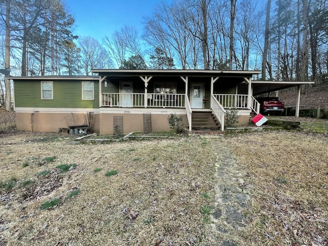 view of front of home featuring covered porch and a carport