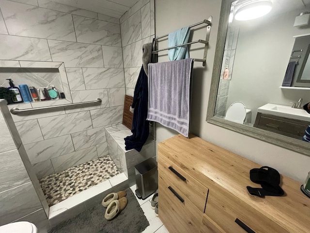 bathroom with vanity and tiled shower