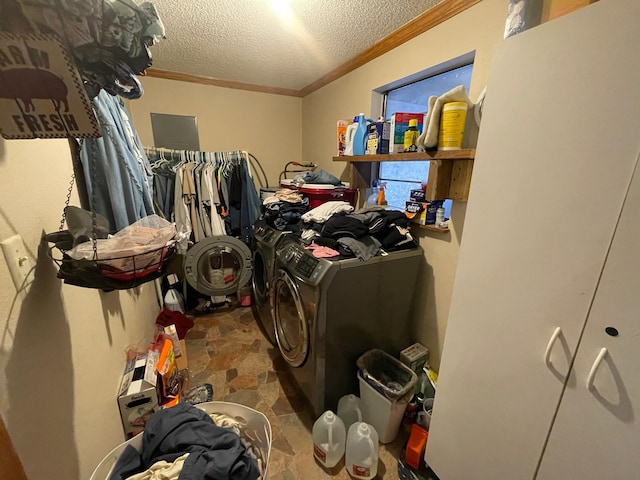 laundry area with washer and dryer, a textured ceiling, and ornamental molding