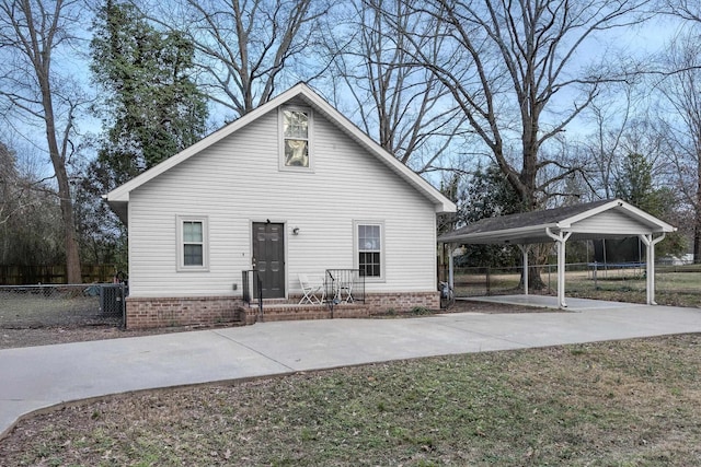 rear view of house featuring a lawn and a carport