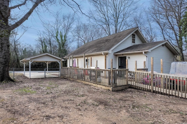 exterior space featuring a wooden deck and a carport