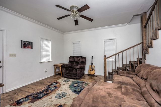 living room with hardwood / wood-style flooring, crown molding, and ceiling fan