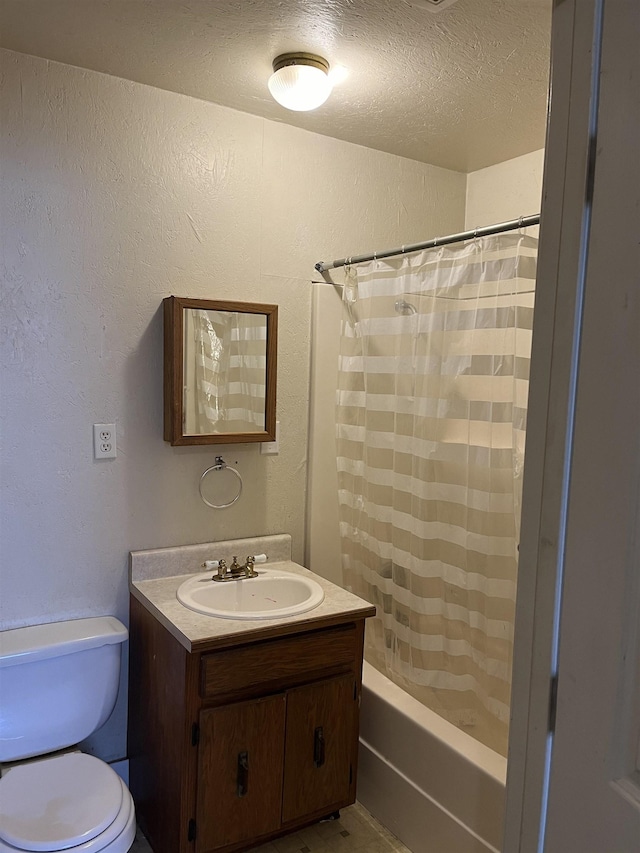 full bathroom featuring toilet, shower / bath combo, vanity, and a textured ceiling