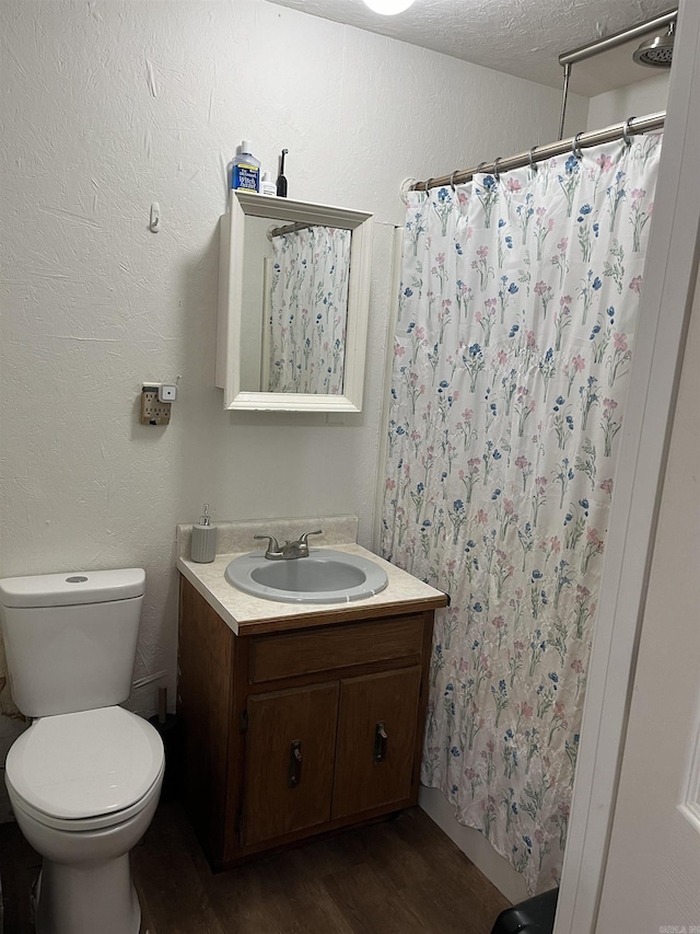 bathroom featuring hardwood / wood-style floors, toilet, a shower with shower curtain, and vanity