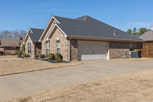 view of front facade with central AC and a garage