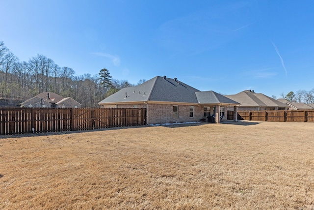 rear view of property with a yard and a patio