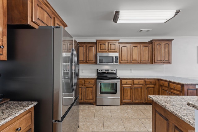 kitchen featuring crown molding, stainless steel appliances, and light stone counters