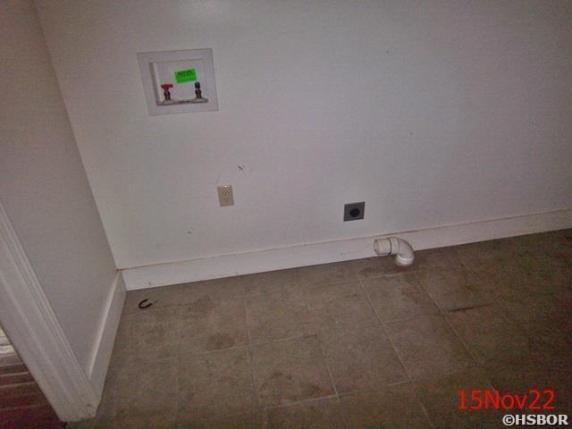 clothes washing area featuring washer hookup, dark tile patterned flooring, and electric dryer hookup