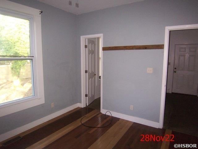 spare room with dark hardwood / wood-style flooring