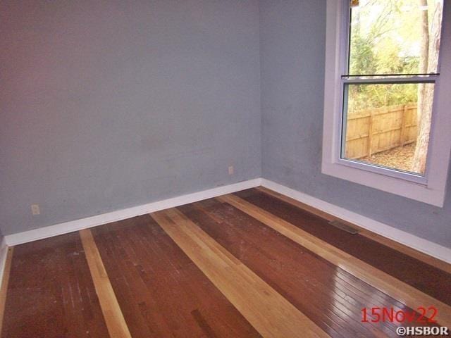 empty room with wood-type flooring