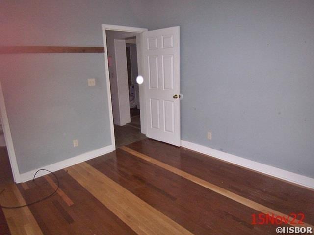 spare room with dark wood-type flooring