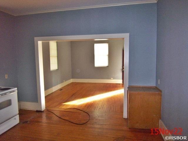 spare room featuring crown molding and wood-type flooring