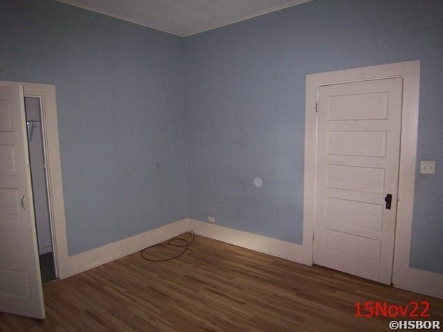 unfurnished room with dark hardwood / wood-style flooring