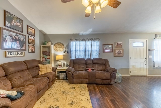 living room featuring hardwood / wood-style flooring, vaulted ceiling, and ceiling fan