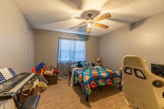 carpeted bedroom with ceiling fan and a textured ceiling