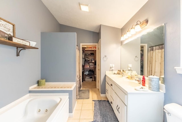 bathroom featuring lofted ceiling, a bath, tile patterned floors, toilet, and vanity