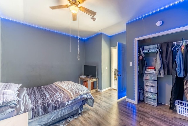 bedroom with hardwood / wood-style floors, a closet, and ceiling fan