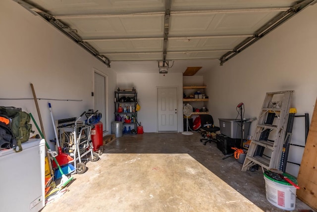 garage with a garage door opener and refrigerator