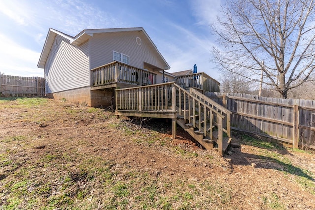 rear view of house featuring a wooden deck