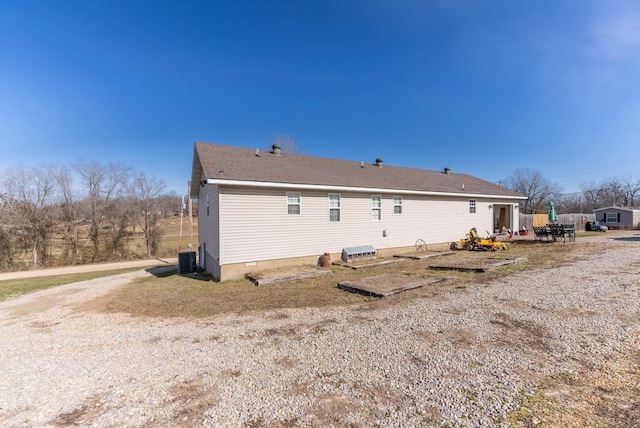 rear view of property with central AC