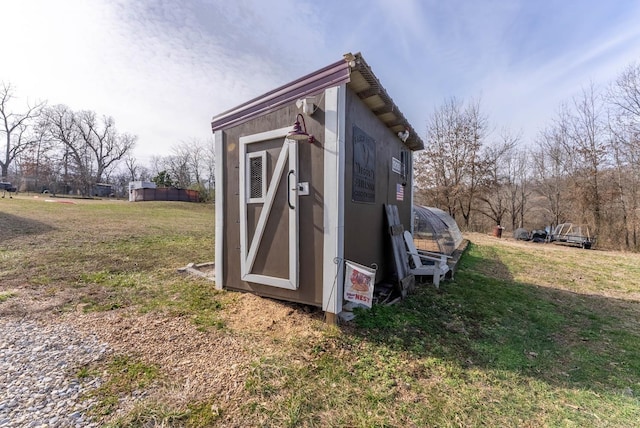 view of outbuilding featuring a lawn