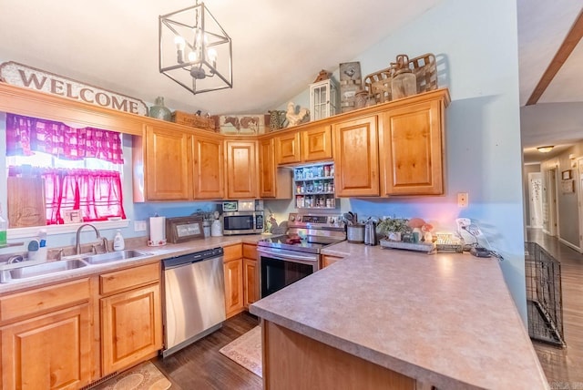 kitchen featuring appliances with stainless steel finishes, lofted ceiling, decorative light fixtures, dark hardwood / wood-style flooring, and sink