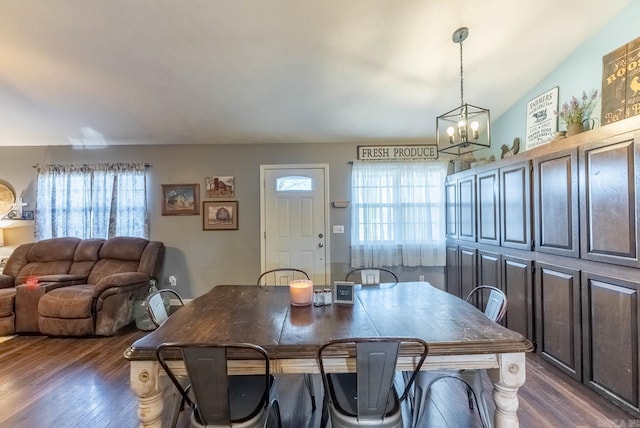 dining room with a notable chandelier, dark hardwood / wood-style floors, and a healthy amount of sunlight