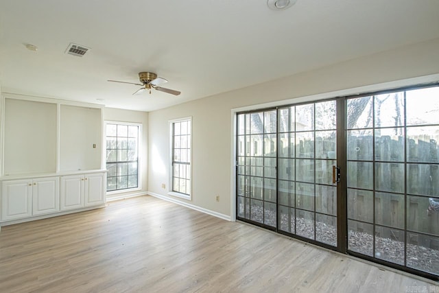 unfurnished room featuring ceiling fan and light wood-type flooring