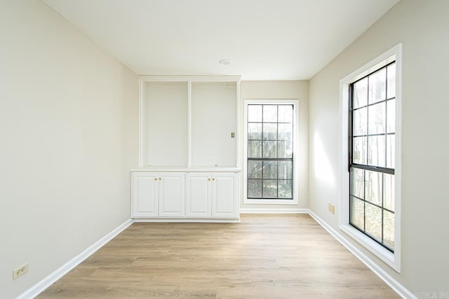 unfurnished room with light hardwood / wood-style flooring