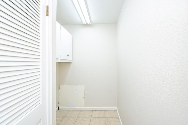 laundry area with light tile patterned flooring