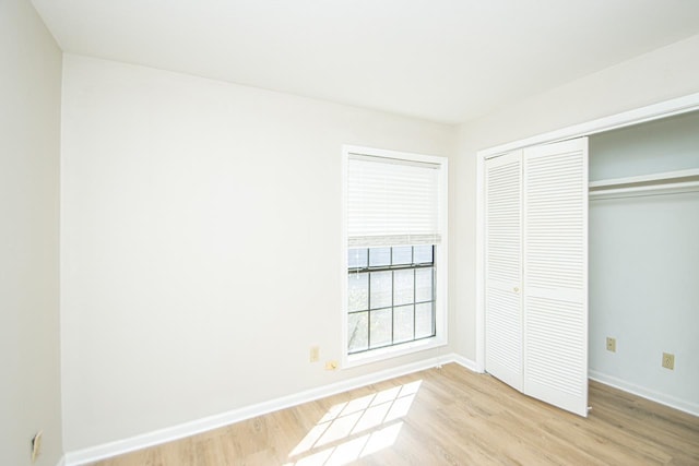 unfurnished bedroom featuring a closet and light hardwood / wood-style floors