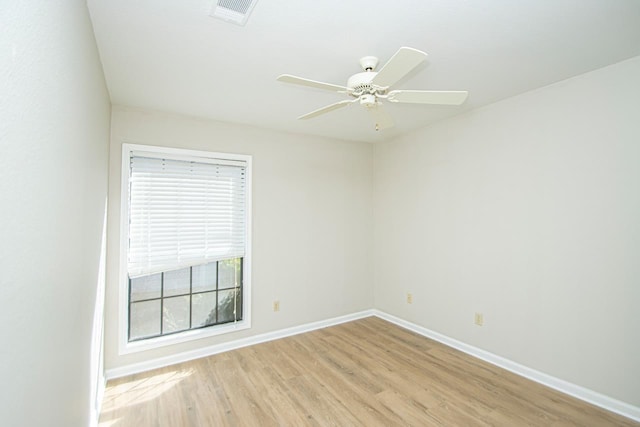 empty room with ceiling fan and light hardwood / wood-style floors