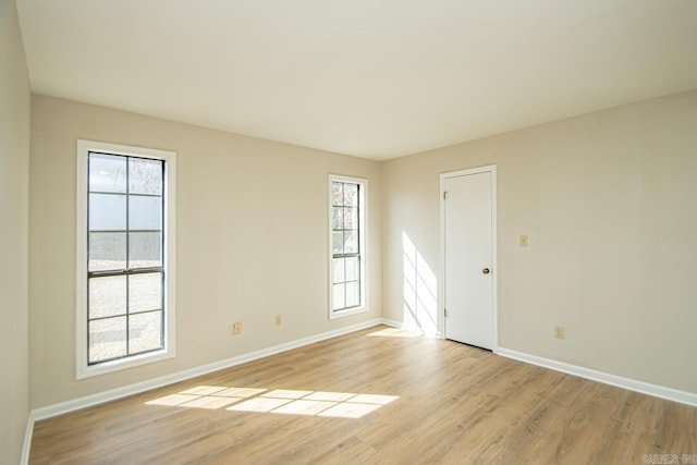 unfurnished room with light wood-type flooring