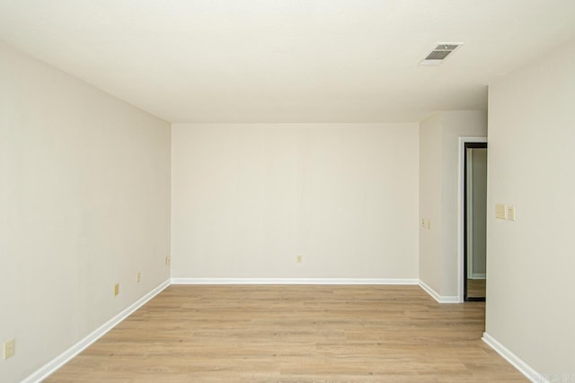 spare room with light hardwood / wood-style flooring