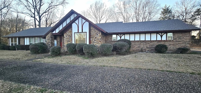 tudor-style house featuring a front lawn