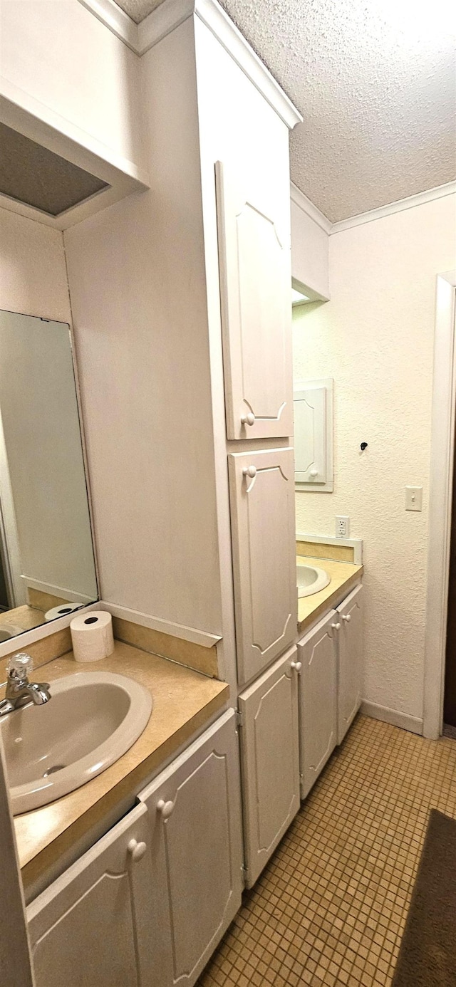 bathroom featuring a textured ceiling and vanity